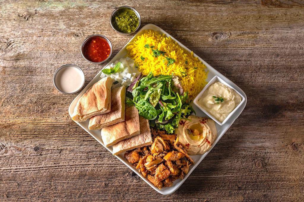 Protein Plate · With your choice of protein, the plate comes with turmeric rice, pita bread, hummus, tzatziki, garlic spread, mixed greens, balsamic vinaigrette, tahini sauce, cilantro mint chutney, and peri peri hot sauce.