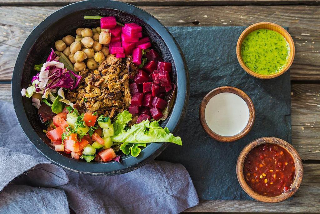 Traditional Bowl · Salad or grain bowl with your choice of protein. Comes with garbanzo beans, wild arugula, cabbage, diced beets, diced pickles and tahini sauce.