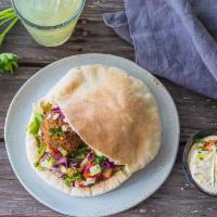 Traditional Falafel Pita · Freshly made falafel in a warm and fluffy pita pocket. Comes with hummus, tomato cucumber mi...