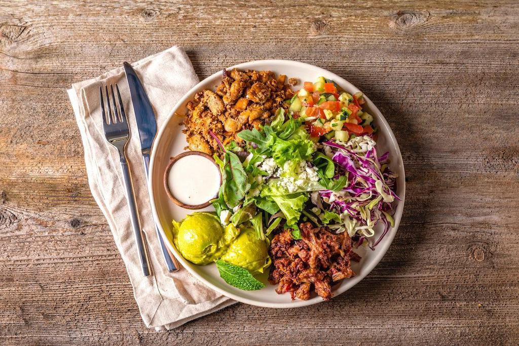 Keto Salad Bowl · Enter a state of ketosis with chicken shawarma on a bed of mixed greens. Comes with sumac cauliflower, tomato cucumber mix, cabbage, avocado, feta cheese and tahini sauce.