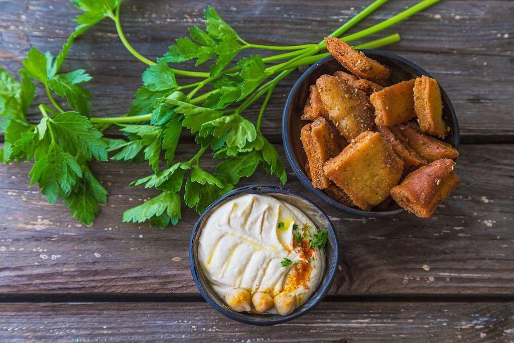Pita Chips · Comes with a small dip, your choice of hummus, tzatziki, or garlic sauce.