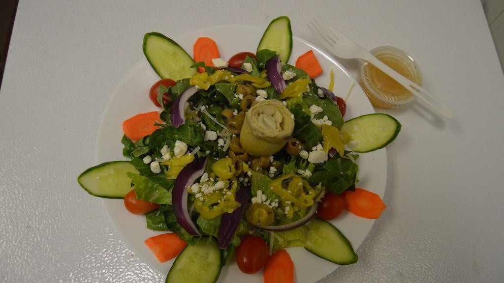 Greek Salad · Romaine lettuce, carrot, red cabbage, cucumber, grape tomatoes, red onions pepperoncini, artichoke hearts, green olives, and feta cheese.