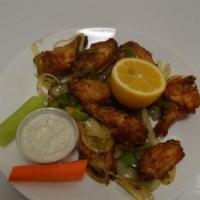 Lemon Chicken Wings · Fried chicken wings sautéed with lemon juice, onions, and bell peppers.