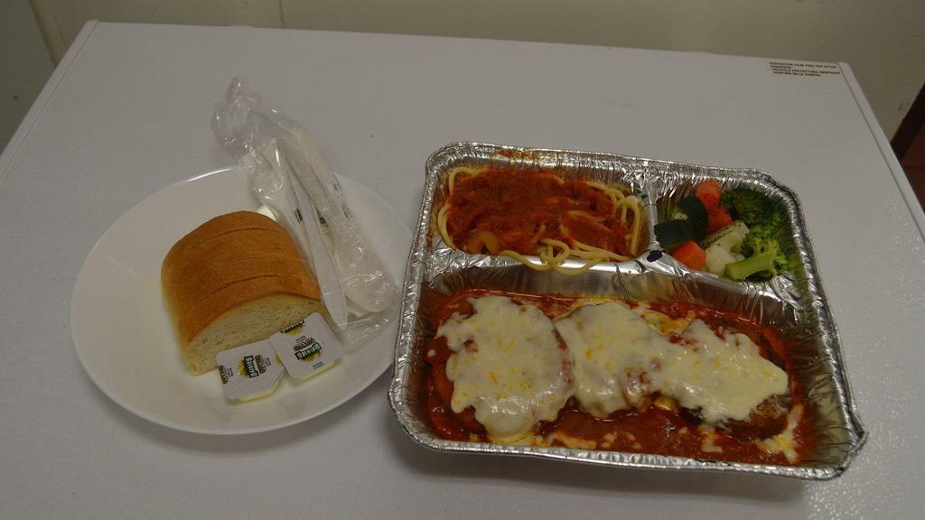 Eggplant Parmigiana · Bread eggplant baked with marinara, Parmesan cheese, mozzarella cheese served with side of pasta, steam vegetables, bread, and butter.