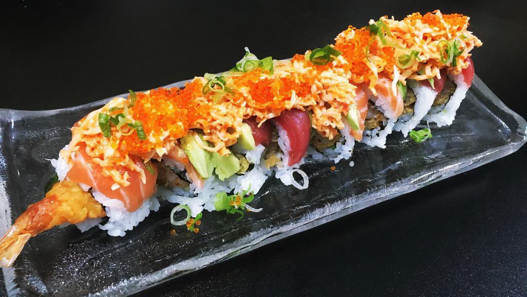 Sunset roll · Shrimp tempura, cucumber wrapped with tuna, salmon & avocado. topped with spicy crab ,flying fish roes & scallion