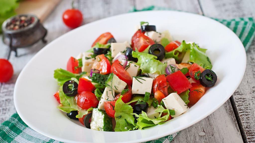 The Greek Salad · Fresh salad made with shredded lettuce, sliced tomatoes, onions, bell peppers, cucumber, pepperoncini, Kalamata olives, and feta cheese with a choice of dressing.