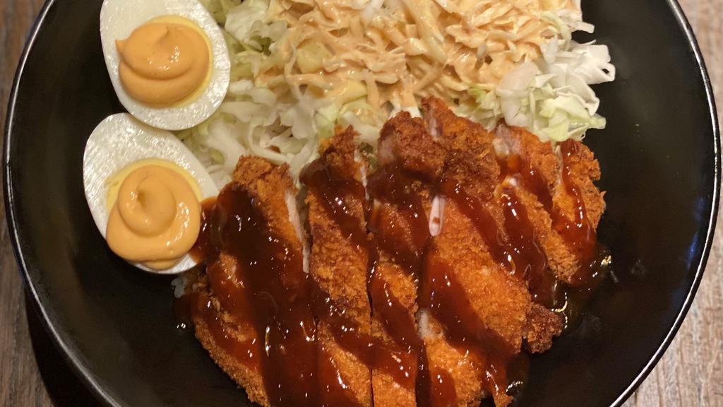 Chicken Katsu Bowl · A chicken cutlet fried katsu style and a hard-boiled egg with chili mayo served on a bed of shredded cabbage and white rice. Katsu sauce and Gyu-Kaku dressing included on the side.