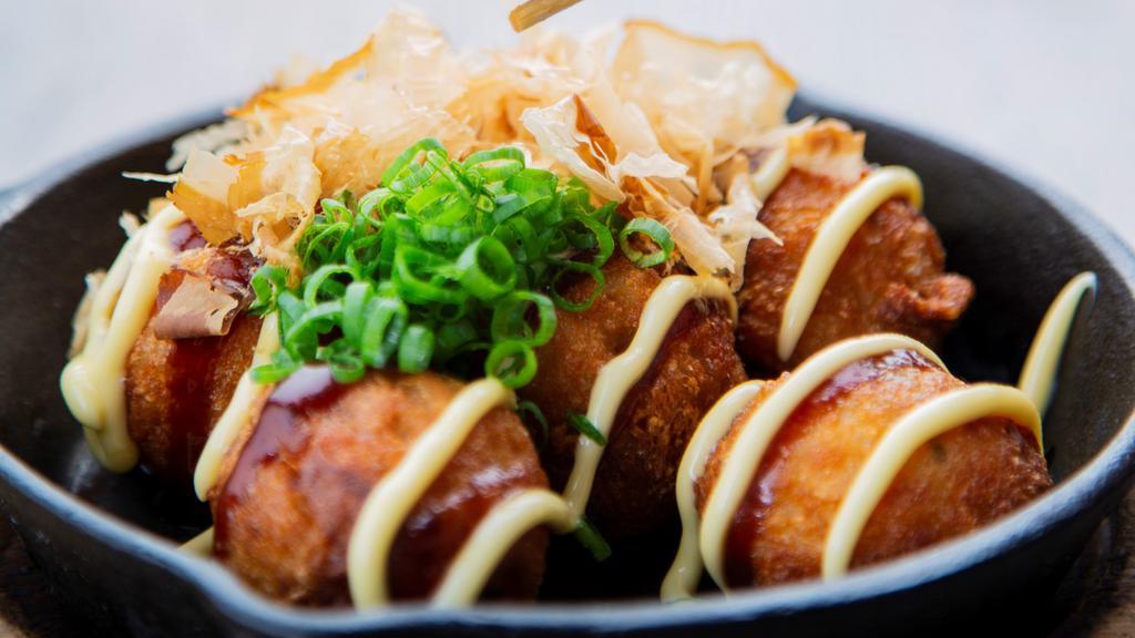 Takoyaki · Fried Octopus Balls! A street food classic straight from Osaka. Six fried octopus fritters drizzled with Takoyaki sauce and Japanese mayo. Topped with crushed bonito flakes and green onions.