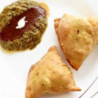 Vegetable Samosa (2 Pieces) · Deep fried pastries filled with mildly spiced potatoes and peas.