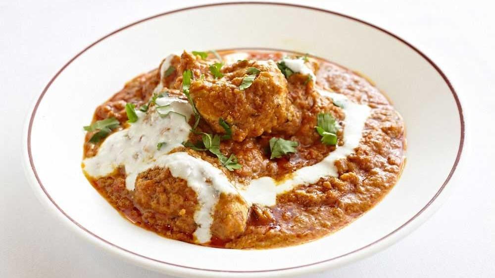 Chicken Tikka Masala · Marinated boneless chicken breast pieces cooked in tandoor oven and then simmered in a thick, spicy curry sauce with ginger, garlic, tomatoes, yogurt, and onions.