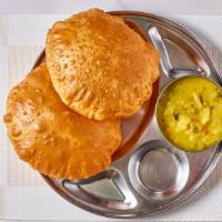 Poori Masala · Fried fluffy whole wheat bread served with potato curry.