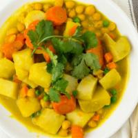 #8.7. Lucky Curry · Spicy, gluten-free. Cauliflower, peas, carrot, garbanzo beans, potato, snow peas in a yellow...