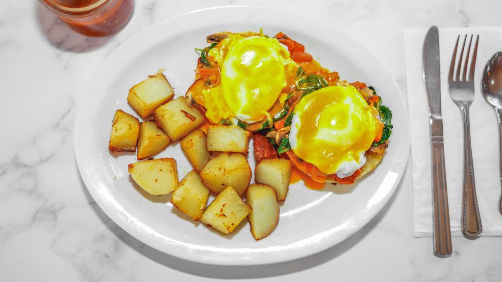 Eggs Popeye · Two eggs poached on an English muffin with spinach, mushrooms, tomato and Hollandaise with home fries.