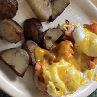 Eggs Benedict · Two eggs poached served on an English muffin with Canadian bacon, Hollandaise with home fries.