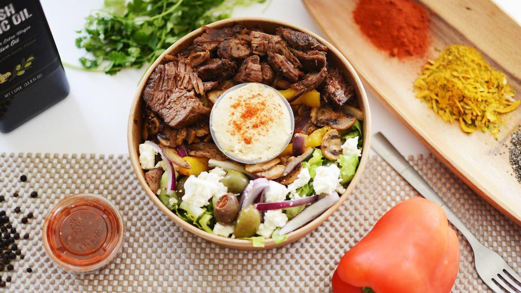 Lamb Rice Bowl · Rice over greek salad with feta cheese and olives accompanied with roasted veggie mix, baked halal lamb, hummus and tzatziki sauce.