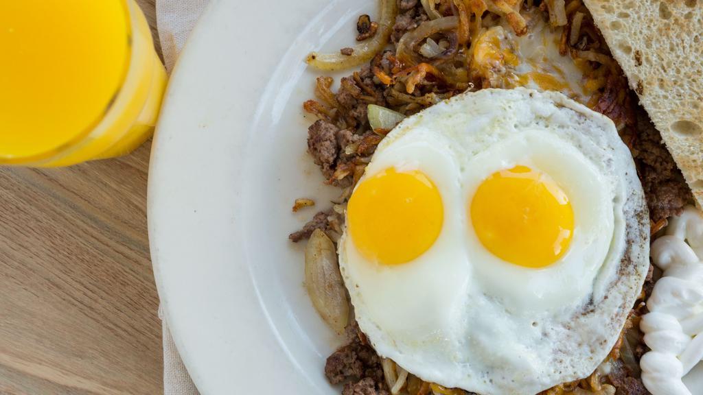 3. Bird's Nest · Housemade ground beef scrambled with fresh hash browns, onions, melted jack and cheddar cheese, two sunny side up eggs, sour cream and toast.