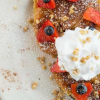 30. Fancy French Toast · Croissant french toast topped with berries, roasted walnuts, whipped cream and powder sugar.