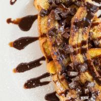 Chocolate Banana French Toast · French toast topped with chocolate chips, grilled bananas, chocolate sauce and powder sugar.