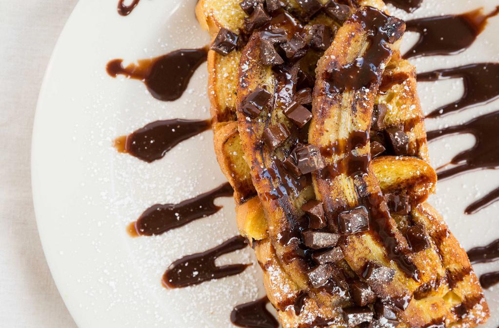 29. Chocolate Banana French Toast · French toast topped with chocolate chips, grilled bananas, chocolate sauce and powder sugar.