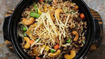 Miracle Fried Rice · Stir-fried brown rice with fried tofu, onion, carrot, spinach and cashew nuts topped with cr...
