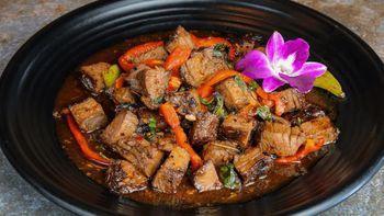 Fire Cook Beef · Grilled flank steak cut dice sauteed with bell pepper, garlic and basil in spicy homemade sa...