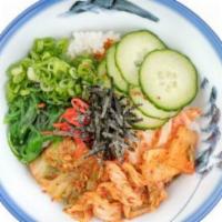 Vegan Kimchi Gohan · Rice bowl with kimchi, wakame, sesame, green onion, spicy sauce, garlic chips, nori.