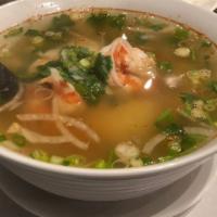 2 Seafood Pho · Noodle soup with fish balls, green mussels, squid, shrimp, imitation crab, onions, and scall...