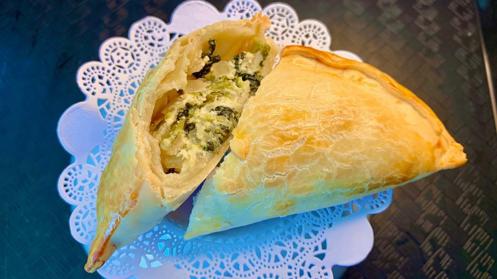 Spinach Feta - Espinaca · Filled with hearty, fresh sautéed spinach, caramelized onions, and white crumbly cow’s milk feta cheese. Finished with a pinch of salt and black pepper.