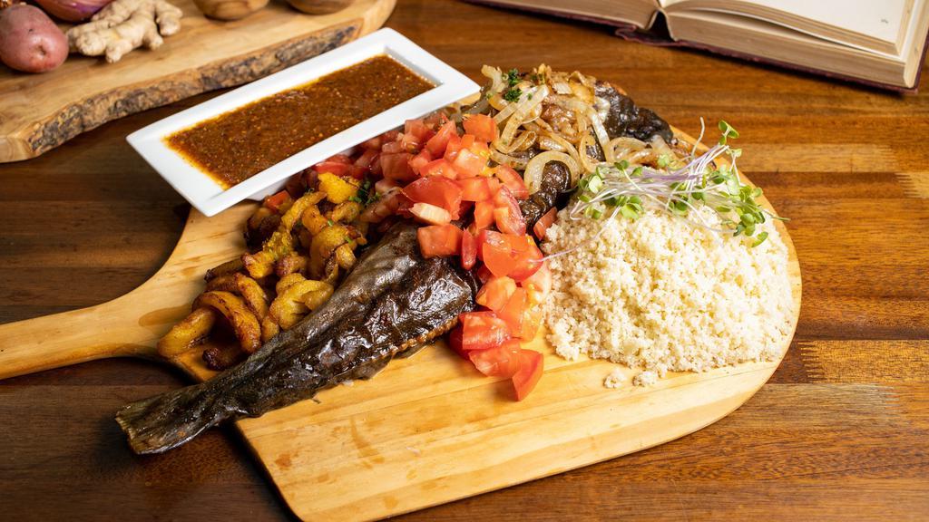 Shoukuya Cancancan ® Black Cod · Whole black cod with bones. Marinated in our proprietary flavorful sauce and grilled in a  tandoor oven served with alloko or attieke, and flamed-grilled onions & tomatoes,  3-5 people –an Omega 3 rich fish  with a buttery flavor like you never had.
