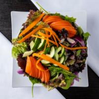 Green Salad · Green mixed with cucumber, tomatoes, red cabbage and carrots with homemade dressing.