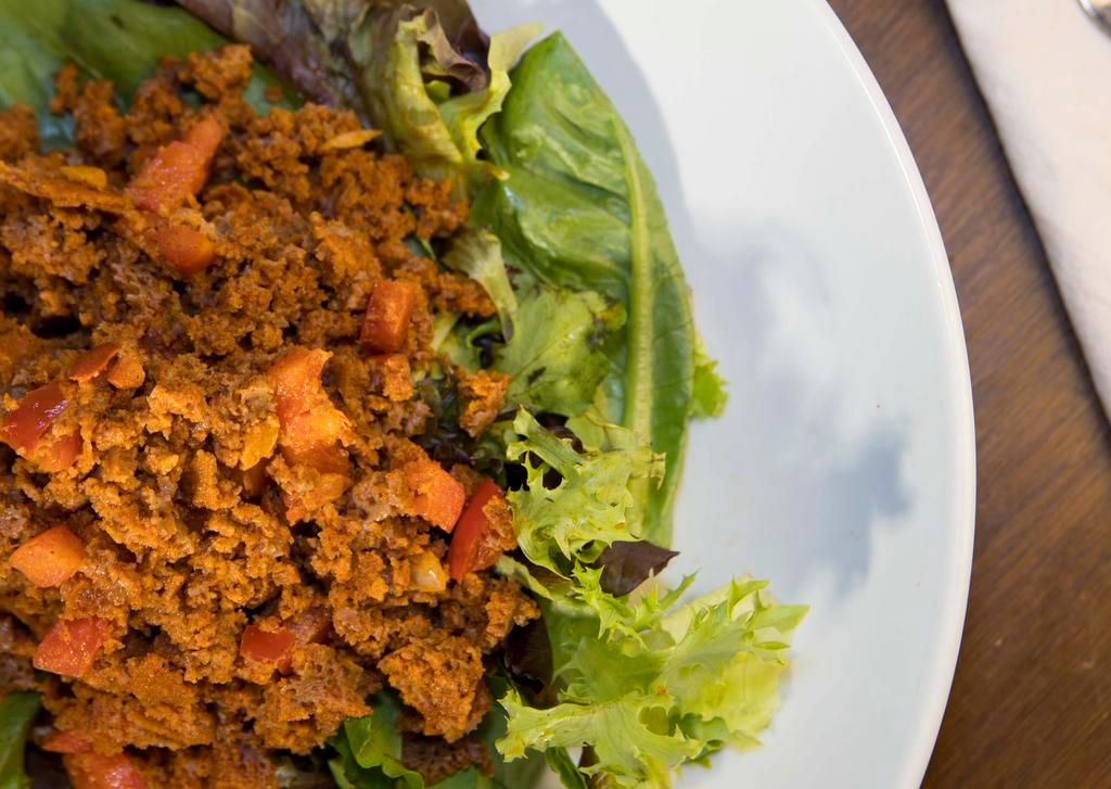 Timatim Salad · Minced injera soaked in tomato sauce and spiced with awaza, onion and green peppers.