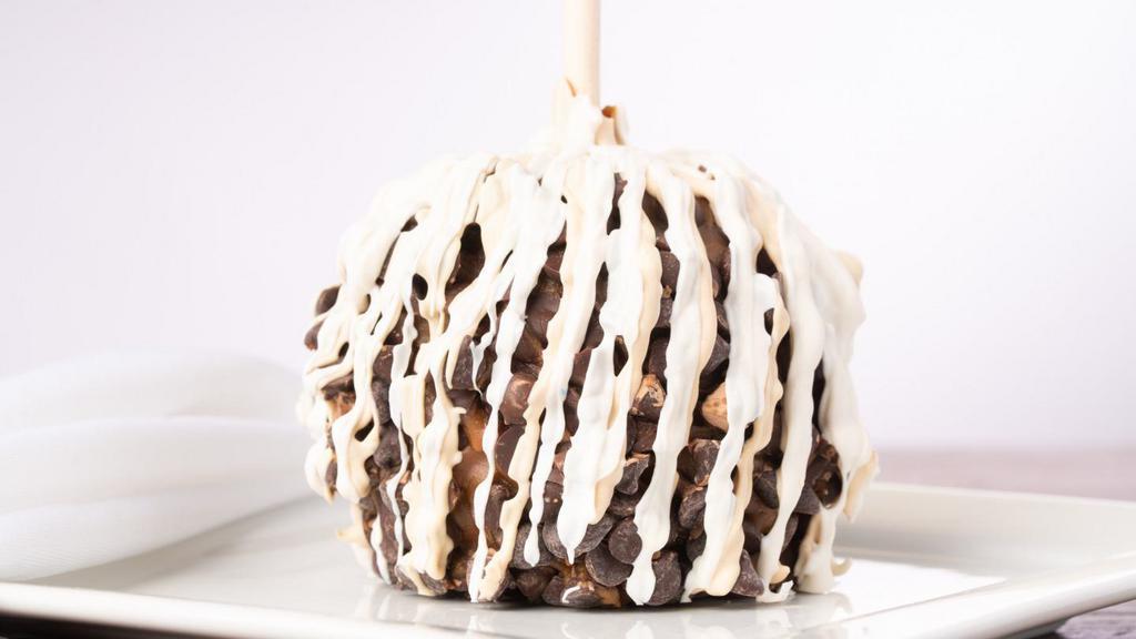Pecan Bear Caramel Apple · A granny smith apple covered in fresh caramel then rolled in chopped pecans, drizzled in milk chocolate and white confection.