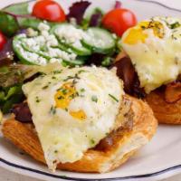 Bacon Gruyère Croissant Egg Toast · Two sunny side up eggs with bacon, gruyere, and onion jam on croissant rolls. Served with se...