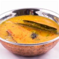 Yellow Daal Masala · Creamy yellow lentil stew prepared with garlic, tomatoes, and fresh spices.