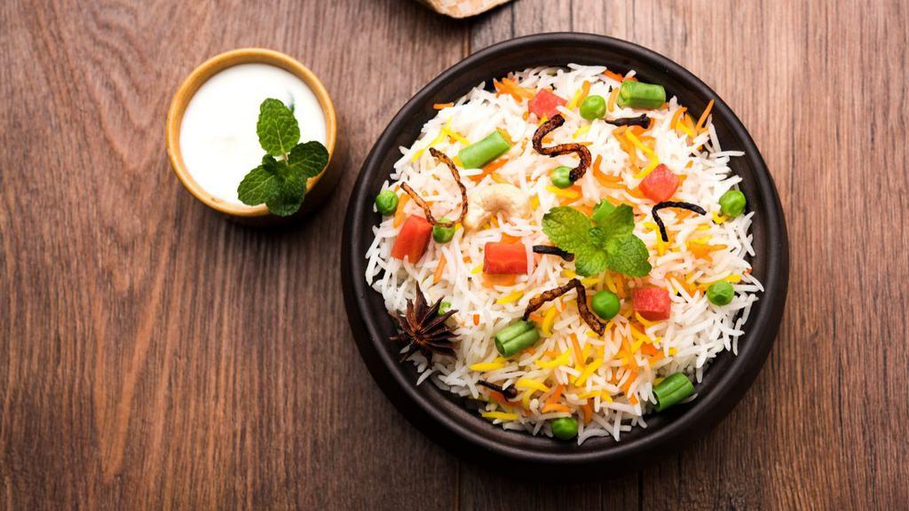 Vegetable Biryani · Basmati rice marinated with Indian spices and locally grown seasonal vegetables.