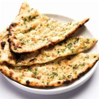 Garlic Naan · Bread stuffed with garlic and backell in a clay oven.