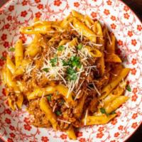 Penne Bolognese with Six-Hour Sauce · 6-hour braised beef, pork, and spicy Italian sausage.