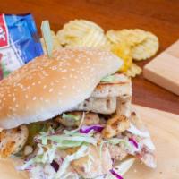 Grilled Chicken Sandwich · Chicken breast in ranch dressing, topped with house slaw, pickles, mayo and served on a bun