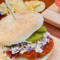 Spicy Chicken Sandwich · Crispy chicken breast swimming in franks hot sauce topped with house slaw, pickles, and serv...