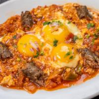 Shakshuka Merguez · 3 eggs cooked gently in Sofrito Saunders with wedges of green peppers & Merguez sausage.