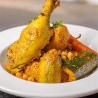 Chicken Couscous  · Traditional Tunisian Couscous in a slightly spicy tomato broth with Tunisian spices.
