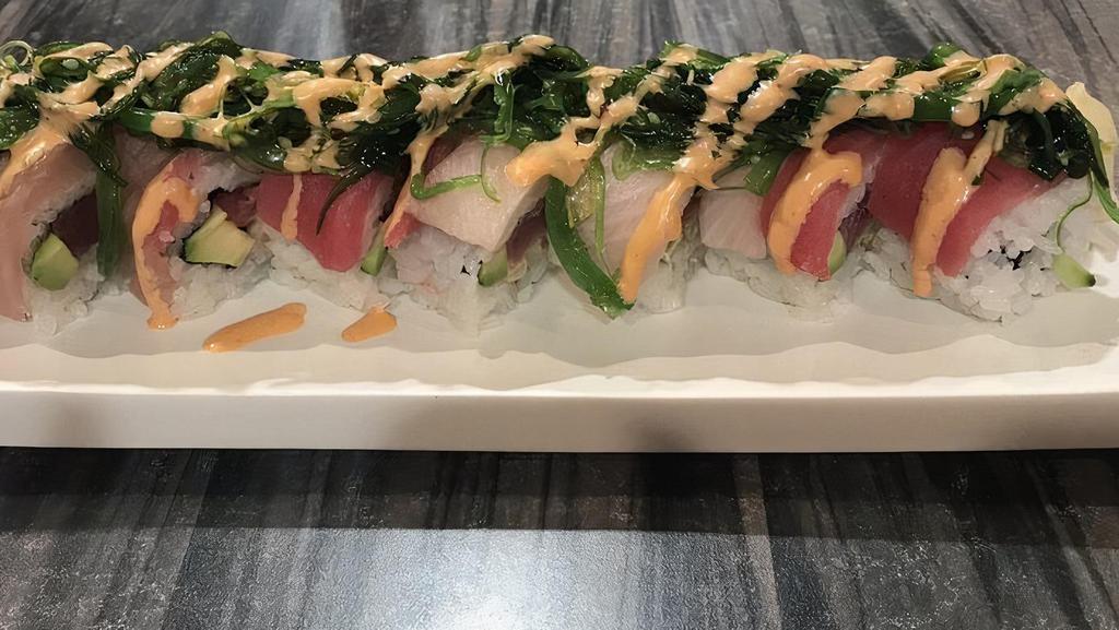 H16. Rock 'n Roll · Tuna, avocado and cucumber, wrapped in tuna, yellowtail and seaweed salad with spicy sauce.