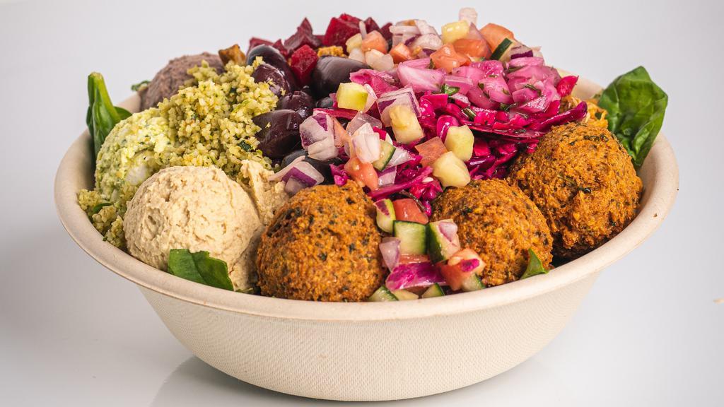 Green & Glowing Power Bowl · Warm, bright, and nutrient dense, made with spinach, Mixed Greens, Traditional Hummus, Kale Salad, Beets, Chickpeas, Olives, Pita Chip Croutons.