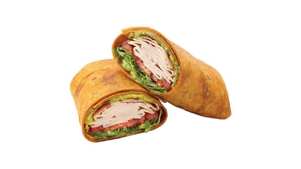 Turkey, Bacon & Guacamole Signature Wrap · The name says it all. A delicious tomato basil wrap filled with a double portion of turkey breast and smoky applewood bacon topped with provolone cheese, guacamole, lettuce, tomatoes, red onions, and ranch.