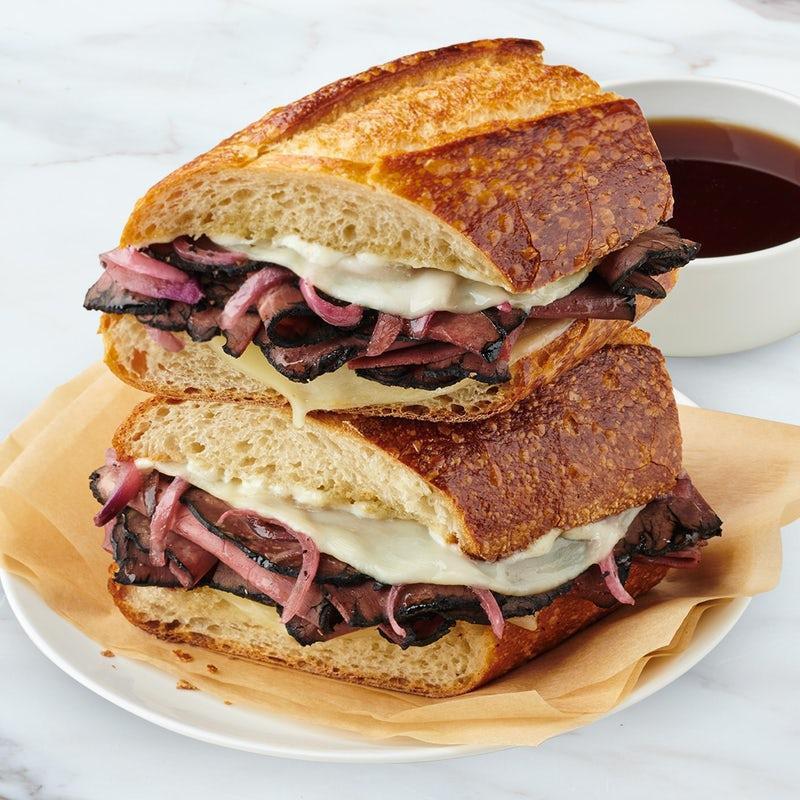 French Dip Deluxe · Roast Beef, provolone, caramelized onions, and horseradish mayo on a toasted sourdough baguette.  Served with Au jus