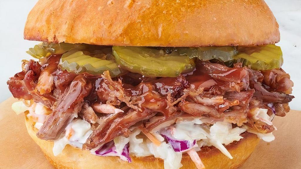 BBQ Pulled Pork Sandwich · Smoked pulled pork, sweet & tangy BBQ sauce, dill pickle slices, house made coleslaw, toasted Boudin brioche bun.