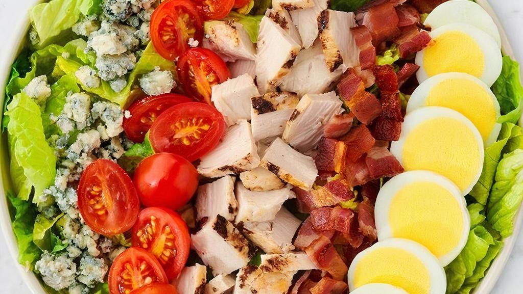 Cobb Salad · All natural diced chicken breast, bleu cheese, applewood smoked bacon, chopped egg, tomatoes, chiffonade romaine lettuce, and ranch dressing.