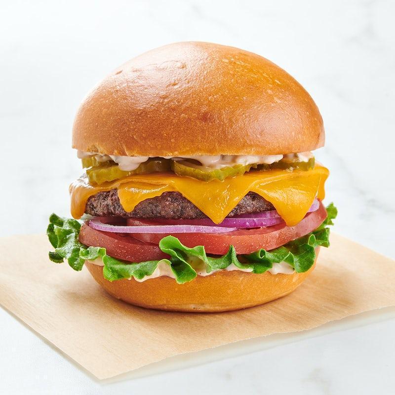 Impossible ™ Burger · IMPOSSIBLE™ burger patty, sharp cheddar, green leaf lettuce, sliced tomato, red onion, dill pickle slices, house-made Russian dressing on a challah bun.