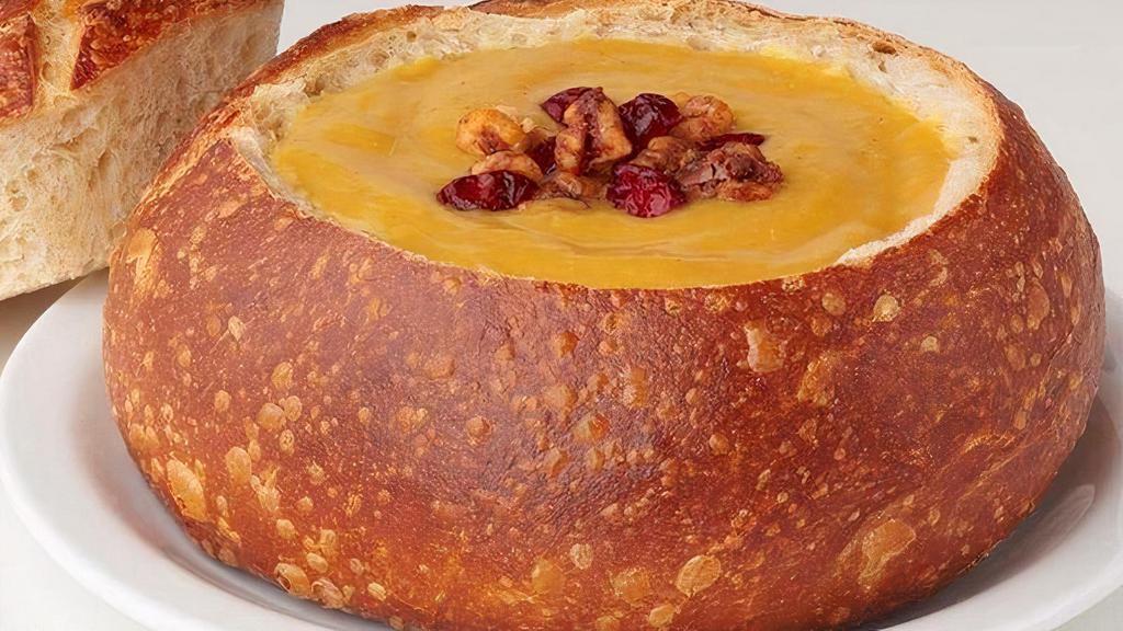 Butternut Squash · Garnished with dried cranberries and spiced walnuts. Nutritional information accounts for soup and 3.8oz of bread bowl top.  (contains nuts)