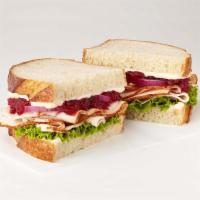 Turkey Cranberry Sandwich · Turkey breast, cranberry sauce, red onion, lettuce, mayo, sliced sourdough.